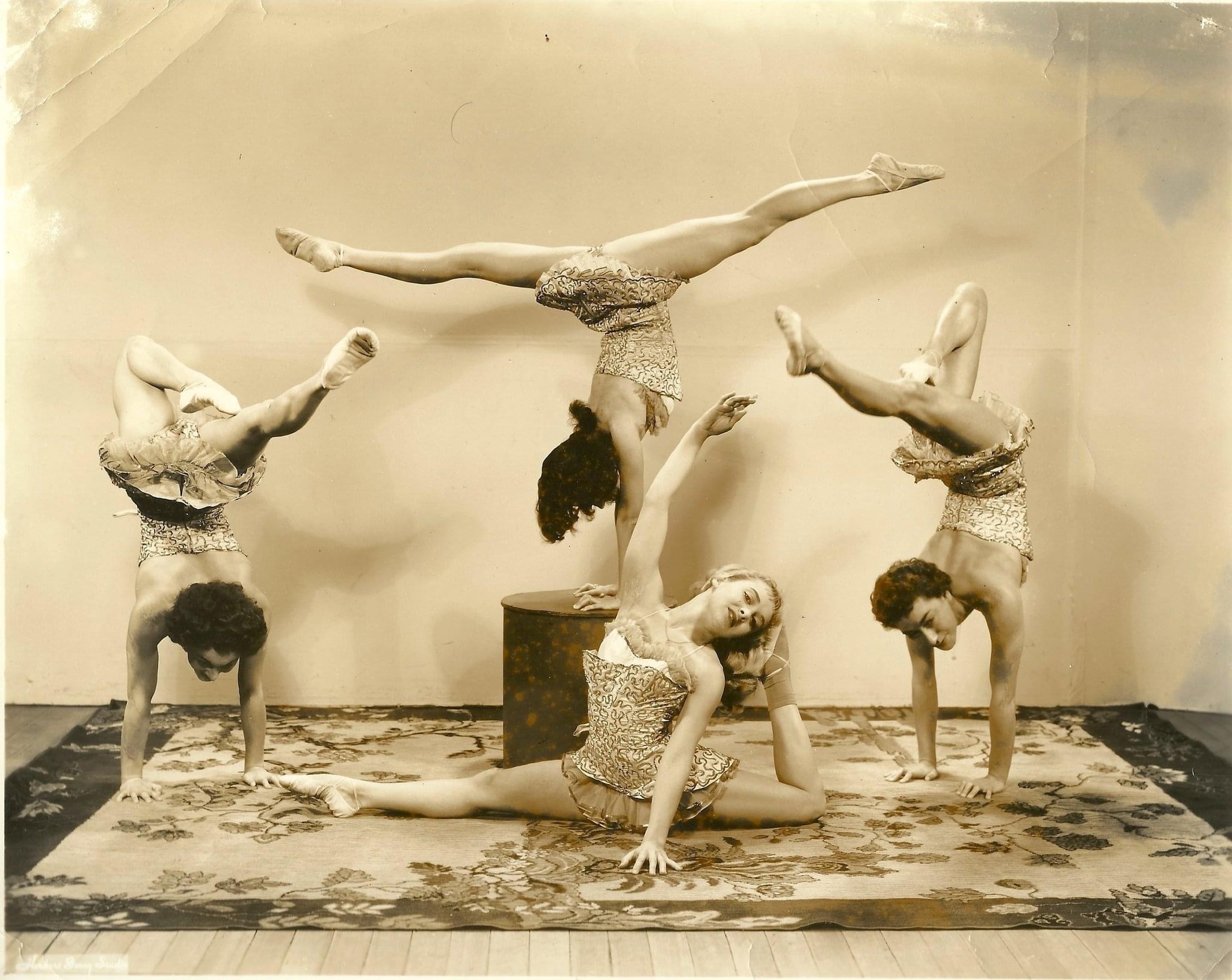 Vintage photograph of four acrobats performing hand balancing and contortion